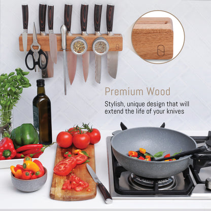 Wooden knife holder with knives, scissors, and spices on a kitchen counter with vegetables and a pan.